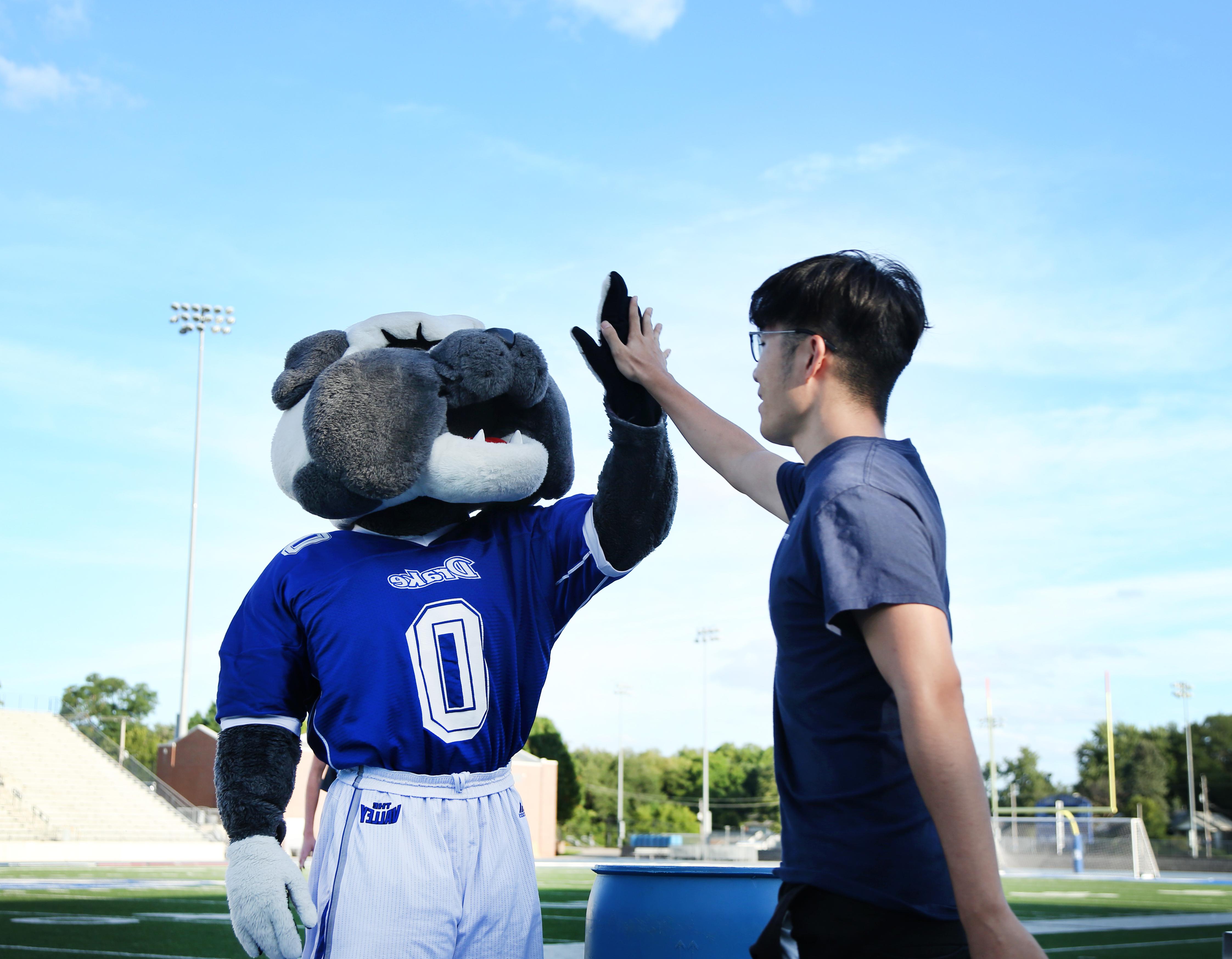 student and spike high fiving