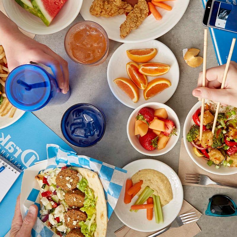 A table full of fresh food and drinks inside of a Drake University dining hall on campus